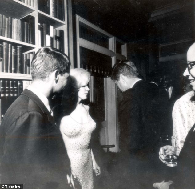 'Passed around': President John F Kennedy and his brother Bobby (left) with Marilyn Monroe